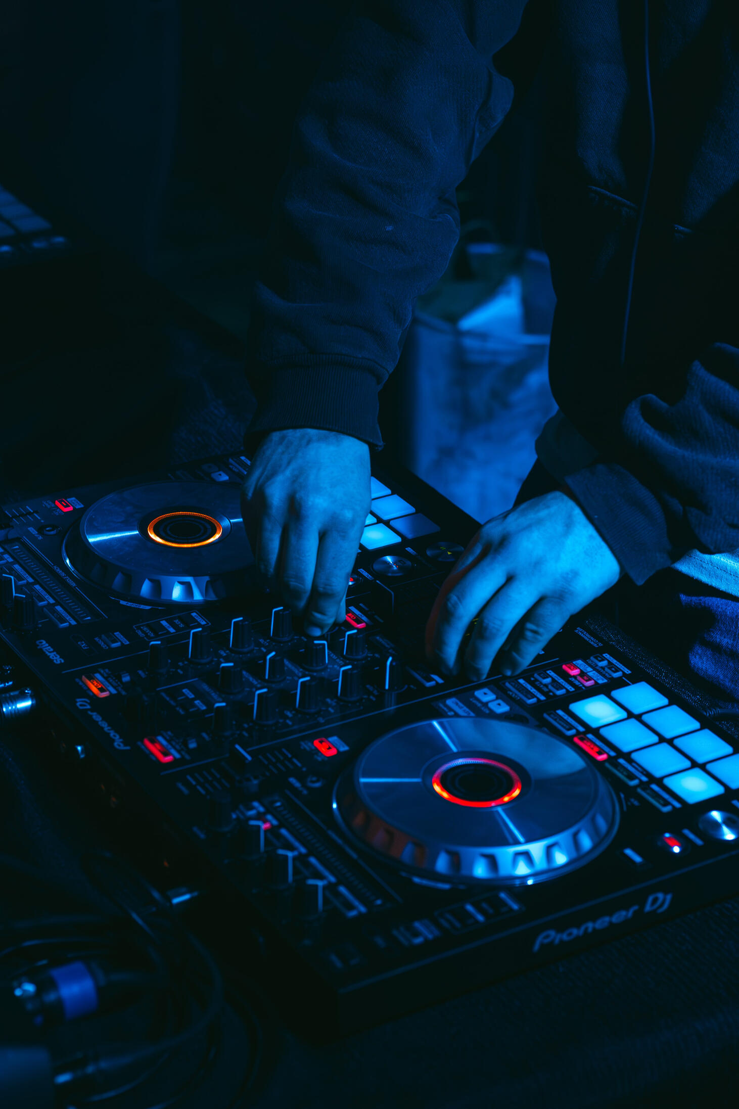 Vault 22 Multiple high-quality MIDI pianos and devices used to produce, mix, and master different music tracks, featured on a clean wood shelf with light shining on them.